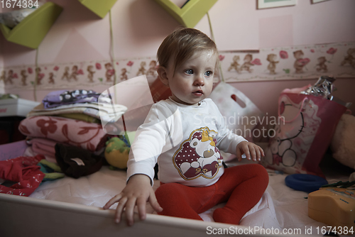 Image of cute little one year old baby and making first steps