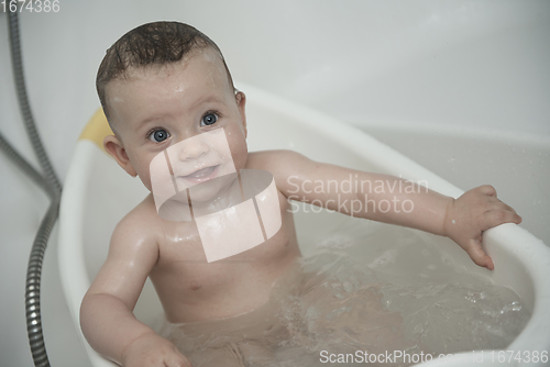 Image of cute little baby girl taking a bath