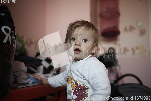 Image of cute little one year old baby and making first steps