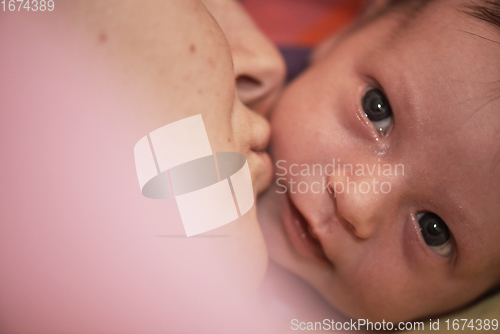 Image of One month newborn baby sleeping in bed