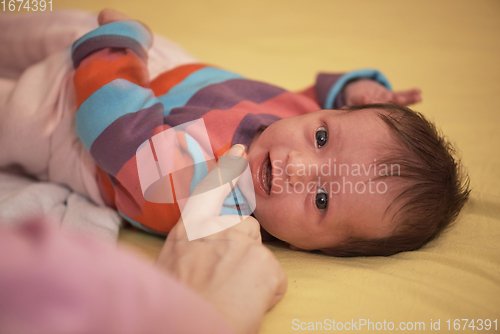 Image of One month newborn baby sleeping in bed