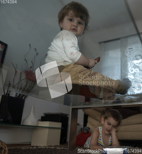 Image of Little child playing with sister at home