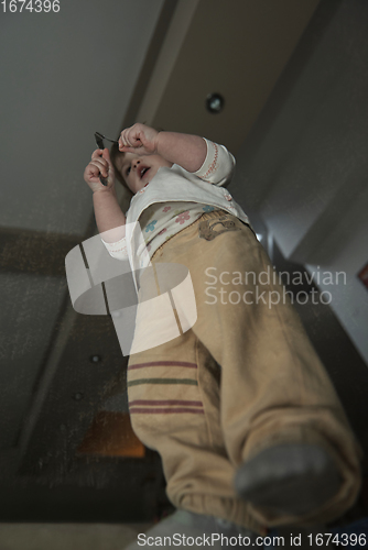 Image of Adorable cute beautiful little baby girl playing with toys at home