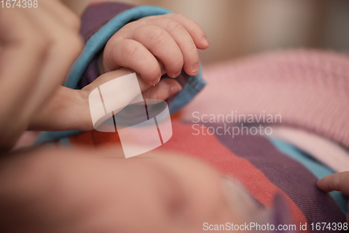 Image of mother is playing with baby at home