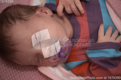 Image of One month newborn baby sleeping in bed