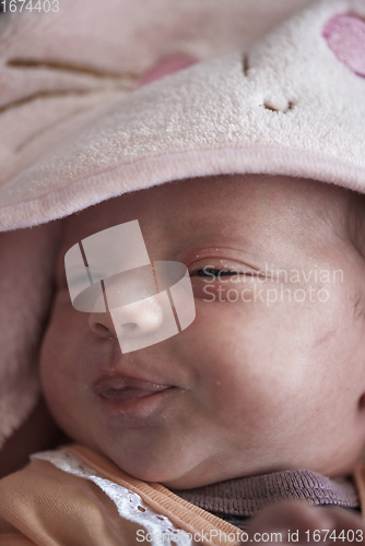 Image of One month newborn baby sleeping in bed