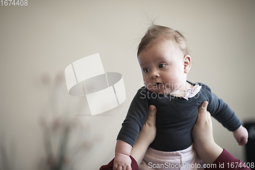 Image of mother is playing with baby at home