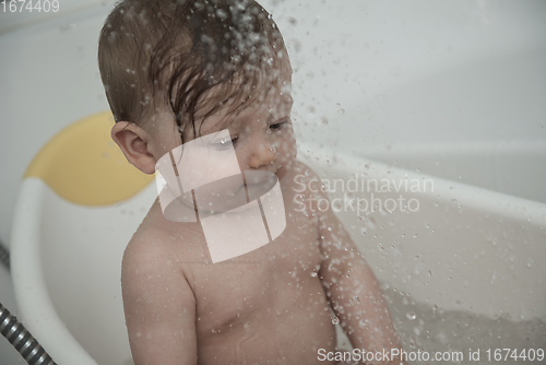 Image of cute little baby girl taking a bath