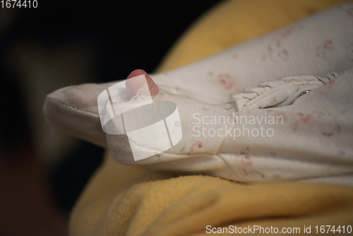 Image of One month newborn baby sleeping in bed