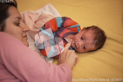 Image of mother is playing with baby at home