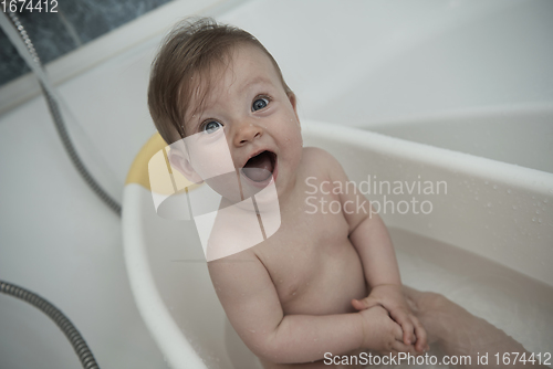 Image of cute little baby girl taking a bath