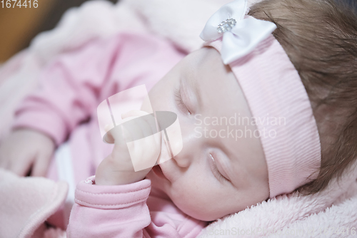 Image of newborn baby sleeping at home in bed