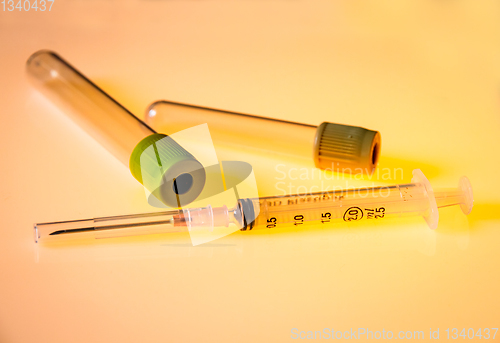 Image of Empty blood test tubes and syringe