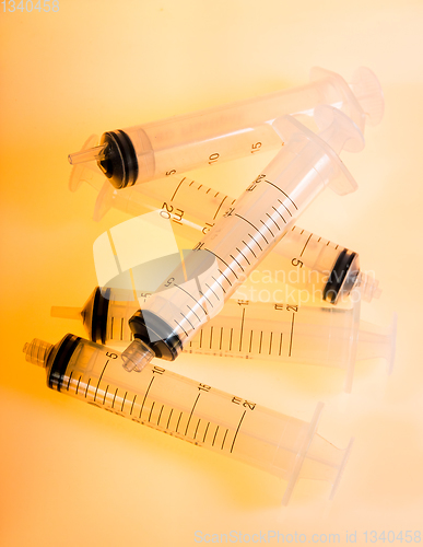 Image of Syringes on orange background