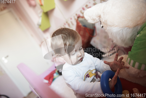 Image of cute little one year old baby and making first steps