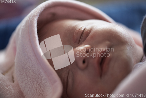 Image of One month newborn baby sleeping in bed