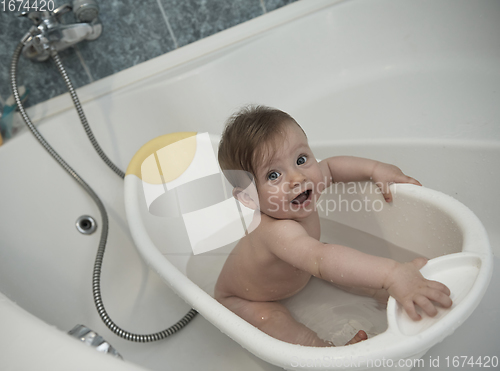 Image of cute little baby girl taking a bath