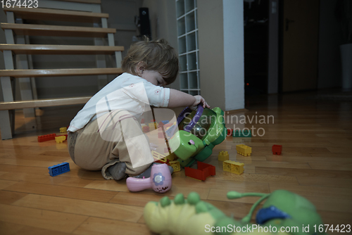 Image of Adorable cute beautiful little baby girl playing with toys at home