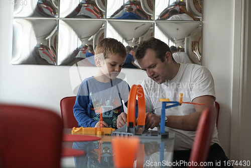 Image of Father and children playing car toy game