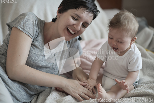 Image of mother is playing with baby at home