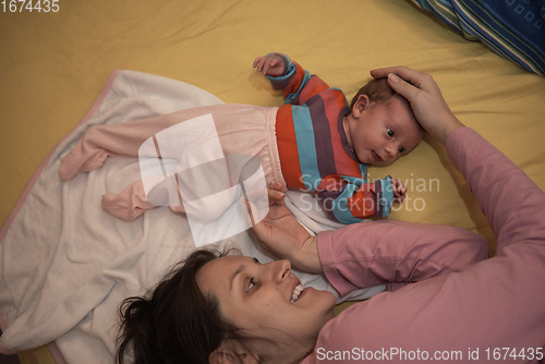 Image of mother is playing with baby at home