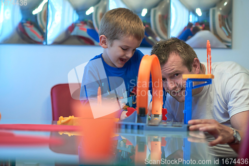 Image of Father and children playing car toy game