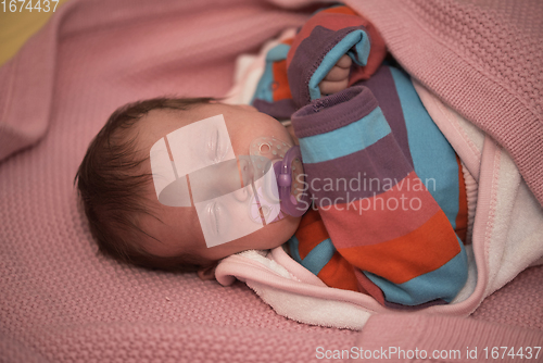 Image of One month newborn baby sleeping in bed