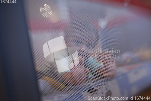 Image of cute little baby playing in mobile bed