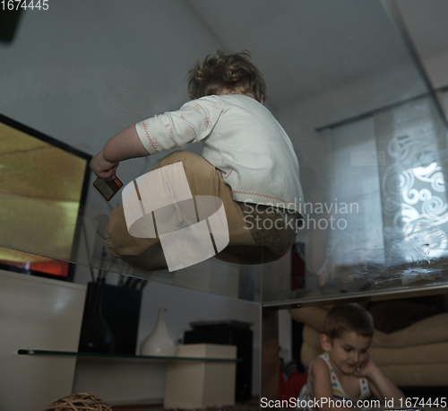 Image of Little child playing with sister at home