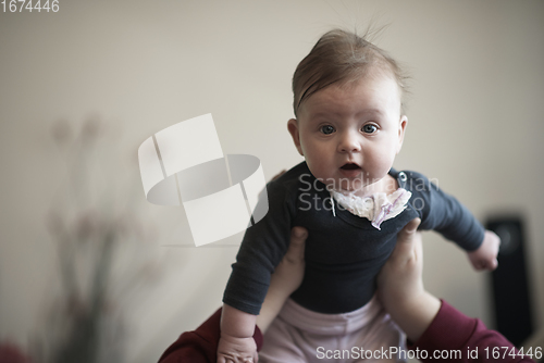 Image of mother is playing with baby at home