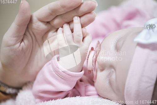 Image of mother is playing with baby at home