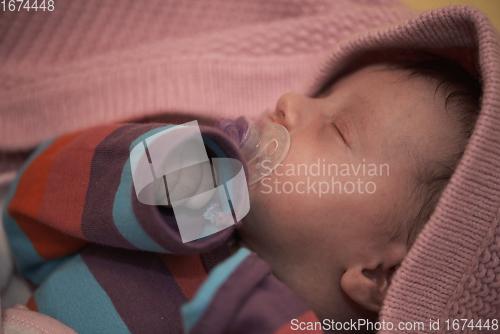 Image of One month newborn baby sleeping in bed