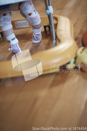 Image of baby learning to walk in walker