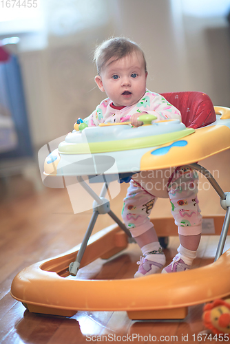 Image of baby learning to walk in walker