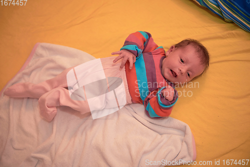 Image of One month newborn baby sleeping in bed