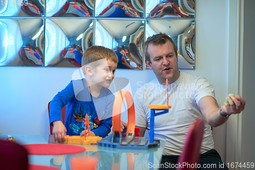 Image of Father and children playing car toy game