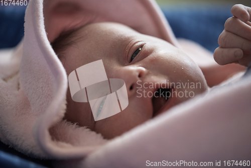 Image of One month newborn baby sleeping in bed