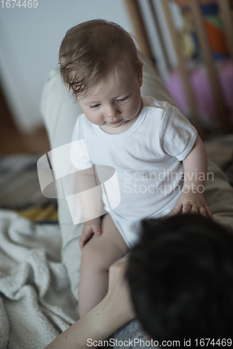 Image of mother is playing with baby at home