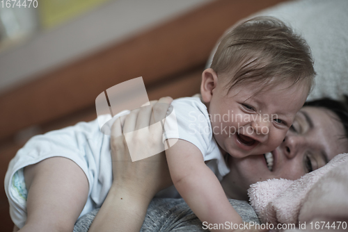 Image of mother is playing with baby at home