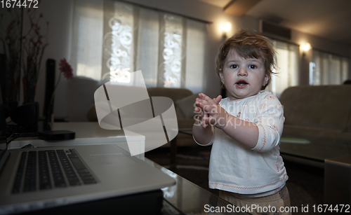 Image of Adorable cute beautiful little baby girl playing with toys at home