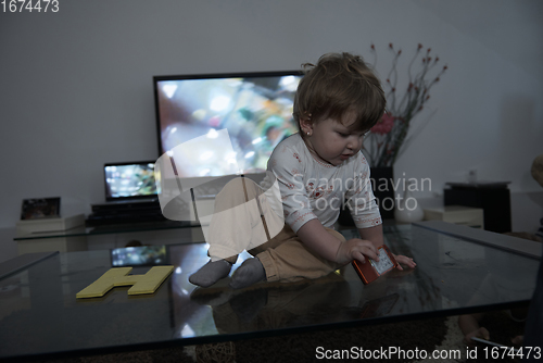 Image of cute little one year old baby and making first steps