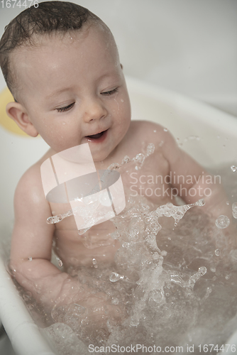 Image of cute little baby girl taking a bath