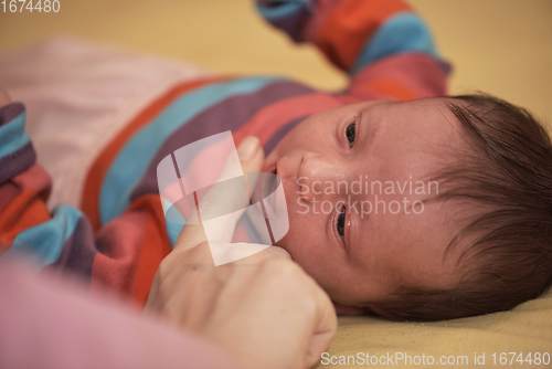 Image of One month newborn baby sleeping in bed