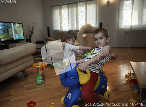 Image of Little child playing with sister at home