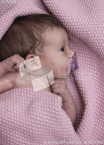 Image of One month newborn baby sleeping in bed