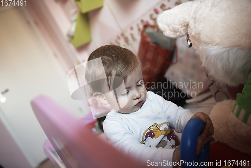 Image of cute little one year old baby and making first steps