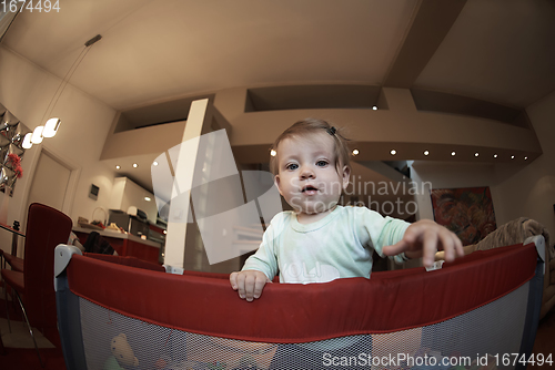 Image of cute little baby playing in mobile bed