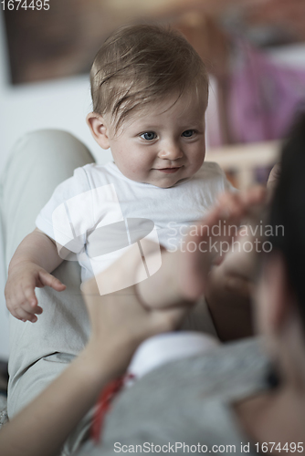 Image of mother is playing with baby at home