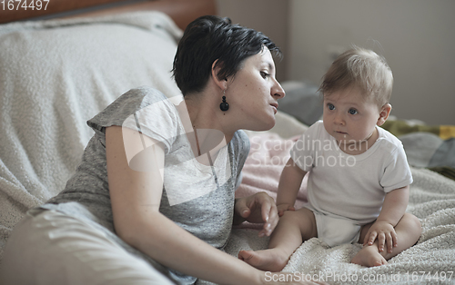 Image of mother is playing with baby at home