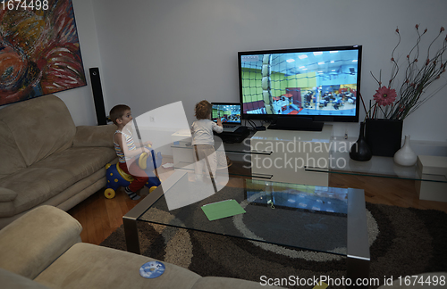 Image of Little child playing with sister at home